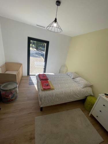 een slaapkamer met een bed en een bank in een kamer bij Maison Des Romarins in Montferrier-sur-Lez