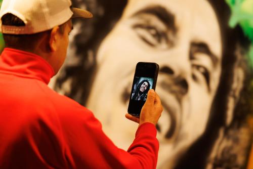 a man taking a picture with his cell phone at ホテルノマド日立 in Hitachi