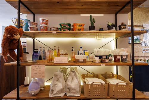 a shelf with baskets and other items on it at ホテルノマド日立 in Hitachi