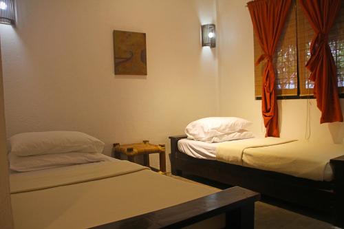 a room with two beds and a window at Lazy Dog Bed & Breakfast in Boracay