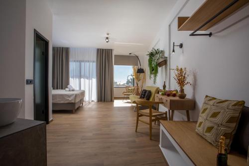 a room with a bedroom and a living room with a bed at 3K Rodo Rooms in Faliraki