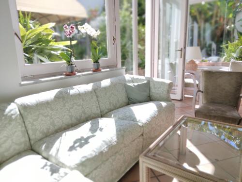 a living room with a couch and a glass table at Hotel Villa Angelica in Ischia