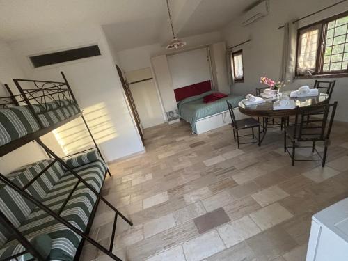 a living room with a table and chairs and a bed at Dimora dei Cardinali in Agropoli