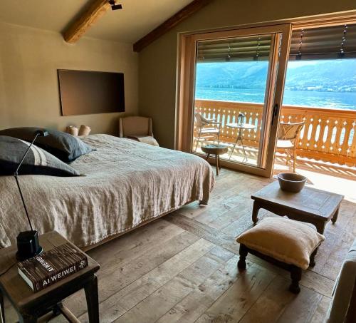 a bedroom with a bed and a view of the ocean at Strandhotel Margaretha in St. Wolfgang