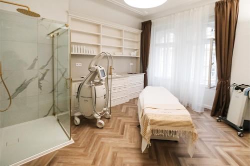 a hospital room with a bed and a shower at Grandhotel Pupp in Karlovy Vary