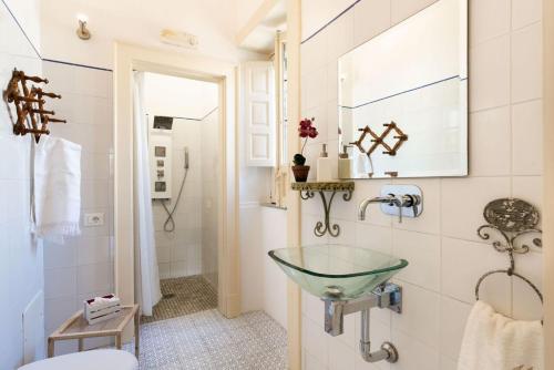 a bathroom with a glass sink on the wall at Villa Voces in Catania