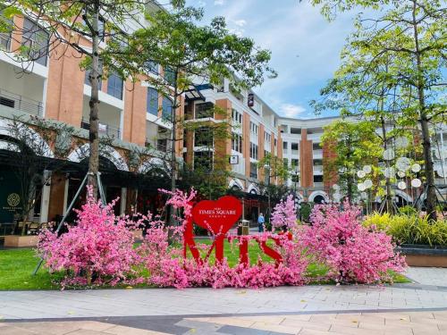 a red heart sitting on top of pink flowers at MiriTimesSquare DAJ#4 Free WI-FI in Miri
