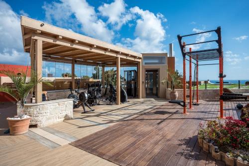 a building with a wooden deck with a basketball hoop at Esperides Resort Crete, The Authentic Experience in Hersonissos