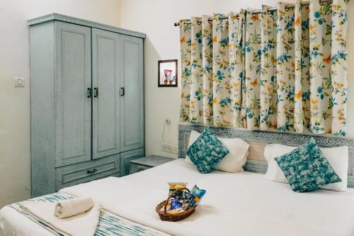 a bedroom with a bed with a green cabinet at Safarnama Varanasi A Boutique B&B in Varanasi