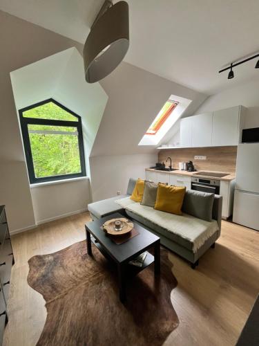 a living room with a couch and a table at JÁNOŠÍK Apartmány in Terchová