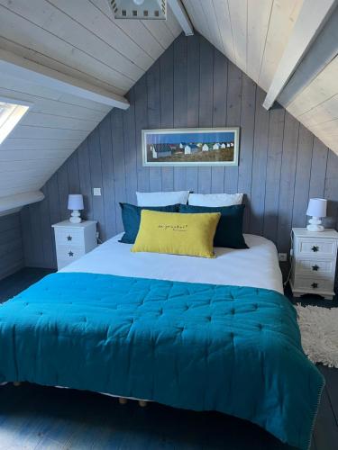 une chambre avec un grand lit aux murs bleus dans l'établissement Le penty, à Ploemeur