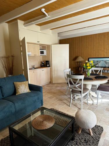 un salon avec un canapé bleu et une table dans l'établissement Le penty, à Ploemeur