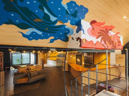 a lobby with a mural of a wave on the wall at Giappo Franca Kyoto in Kyoto