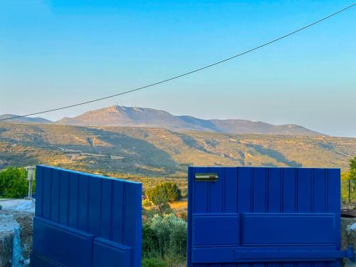 a blue door with a view of a mountain at To Provetzino in Viarádhika