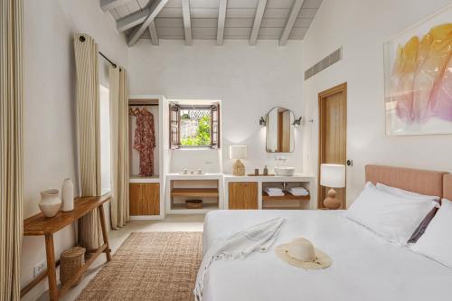 um quarto com uma cama e uma casa de banho com um lavatório em Teresa Spetses em Spetses
