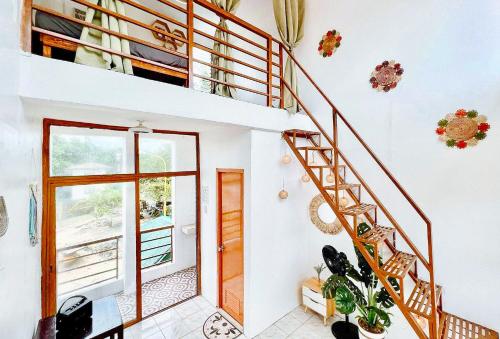 a staircase in a home with white walls at The Lavana Villa Del Matabungkay by RedDoorz in Lian