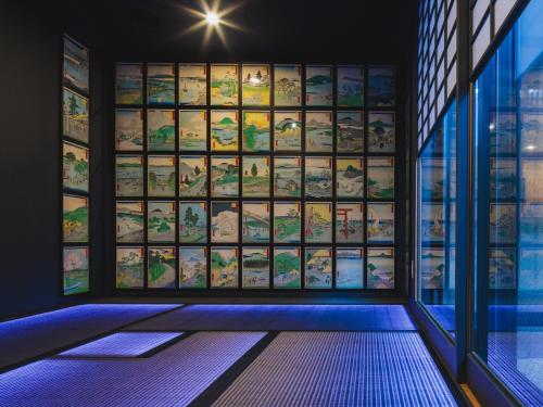 a room with a wall of books in a window at Giappo Franca Kyoto in Kyoto