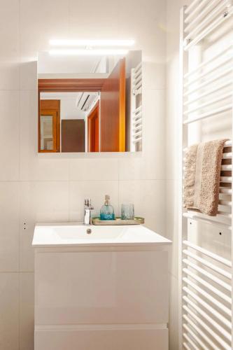 a bathroom with a white sink and a mirror at Riviera Paradiso in Aghia Marina