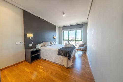 a bedroom with a bed and a large window at Eslanzarote Arrecife 360º Rooftop Suite, Super wifi in Arrecife