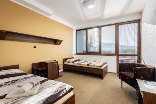 um quarto com 2 camas e uma grande janela em Marina Labe em Píšťany