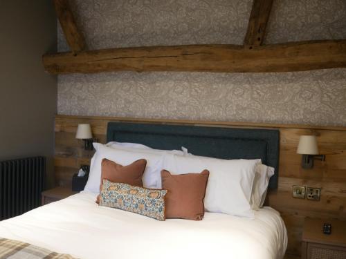 a bedroom with a white bed with pillows on it at Queens Head Inn & Restaurant in Hawkshead