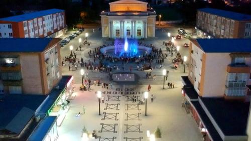 an aerial view of a plaza in a city at night at Cozy apartment in the heart of the city in Hunedoara