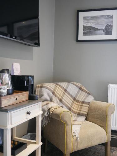a living room with a chair and a table at Queens Head Inn & Restaurant in Hawkshead