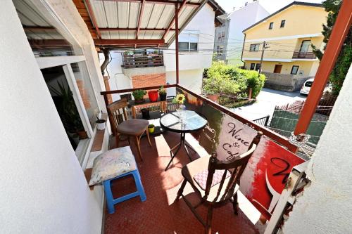 a balcony with a table and chairs on a balcony at Blue Lake hostel in Ohrid