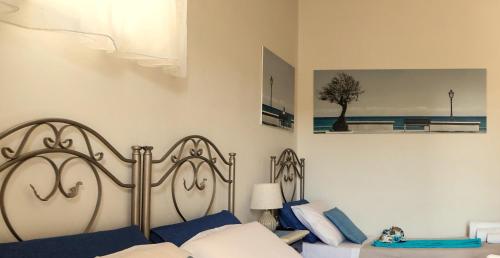 a bedroom with a bed with blue and white pillows at B&B La Porta D'Oriente in Martano