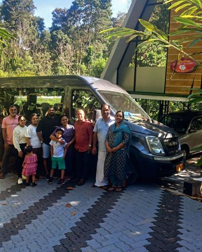 a group of people standing in front of a van at ARABIAN HOLIDAY RESORT WITH SWIMMING POOL IN IDUKKI Calvary Mount in Idukki