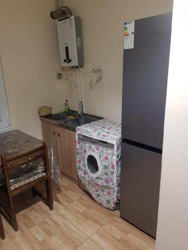 a kitchen with a refrigerator and a washing machine at IDEA Guest House / ИДЕА гостевой дом in Alaverdi