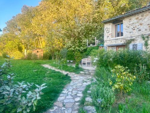 a garden with a stone path leading to a building at La Source in Rustrel