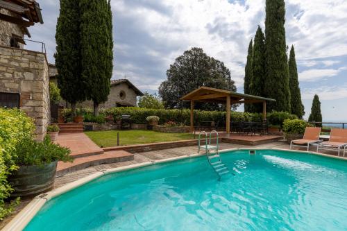 a swimming pool in a yard with a gazebo at La Petrosa in Radda in Chianti