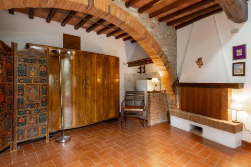 a room with a large wooden cabinet in a kitchen at La Petrosa in Radda in Chianti