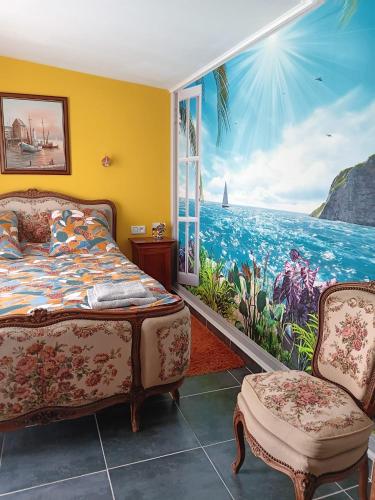 a bedroom with a mural of the ocean at Chez Vladimir in Criquebeuf-en-Caux