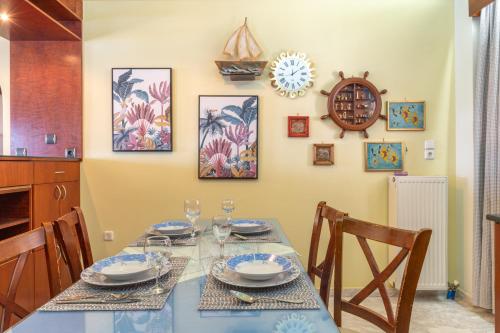 a dining room with a blue table and chairs at The Lalouda of Mani in Gythio