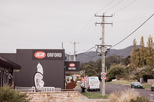 a gas station with a sign on the side of a road at 'Sisters' - Cliff top cabin with hot tub in Spring Beach