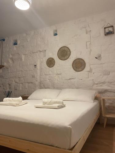 a white bed with two towels on top of it at Casa Mia in Mola di Bari