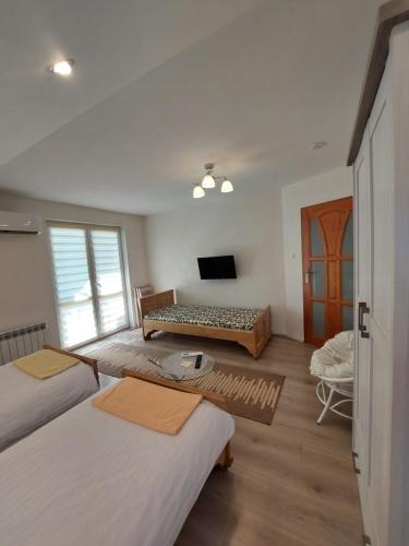 a room with two beds and a television in it at Noclegi Szczebrzeszyn in Szczebrzeszyn