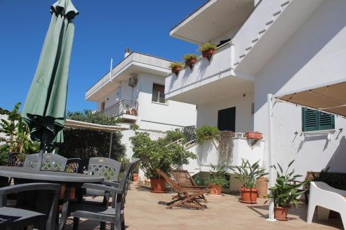 a patio with a table and chairs and a building at B&B La Porta D'Oriente in Martano