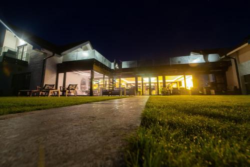 a house at night with a pathway in front of it at Amber VIP Hotel in Pāvilosta
