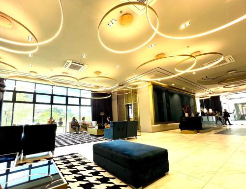 a lobby with a couch in the middle of a room at Grand Residences by Isla Stays in Cebu City