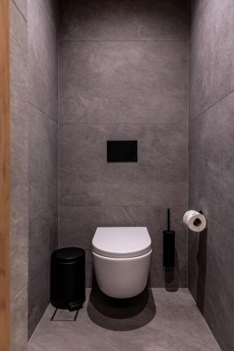 a bathroom with a white toilet in a room at Evanik Chic Hotel in Kalymnos