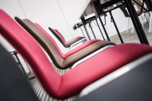 a row of red seats on a bus at Holiday Inn Lübeck by IHG in Lübeck
