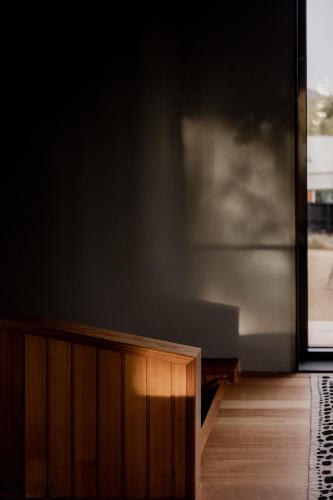 a living room with a large painting on the wall at 'Sisters' - Cliff top cabin with hot tub in Spring Beach