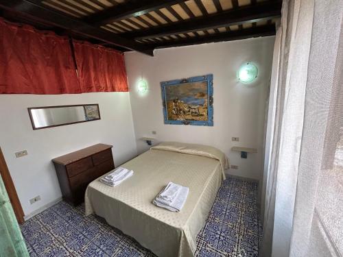 a small bedroom with two beds and a window at Federico Re in San Vito lo Capo