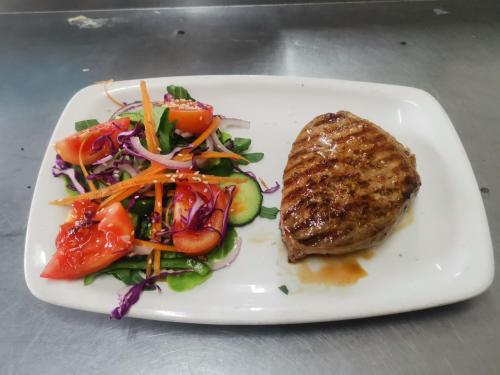 a plate of food with a salad and meat at Kings Lodge Hotel in Hogsback