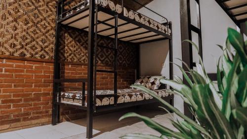 a black bunk bed in a room with a brick wall at Glory Homestay in Yogyakarta