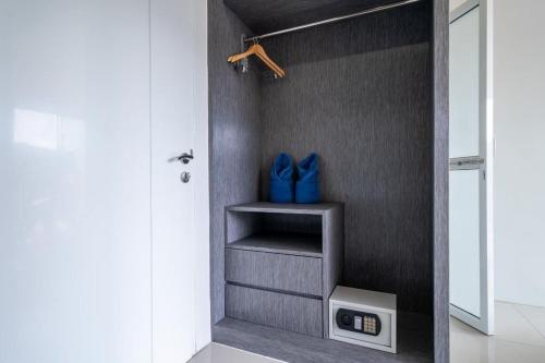 a walk in closet with blue bags on a shelf at The Thames Pool Access Resort & Villa - SHA Extra Plus in Chalong 