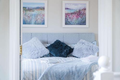 a bedroom with a bed with two pillows on it at Highfield - 5 Bedroom Holiday Home - Pembroke Dock in Pembroke Dock
